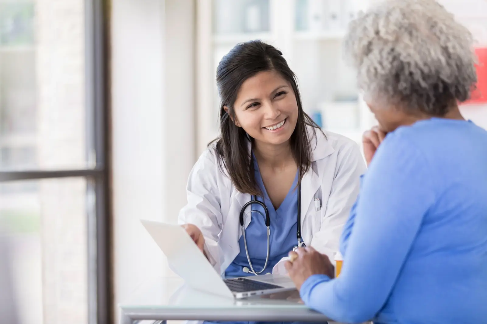 Nurse reviewing lab results with a senior patient