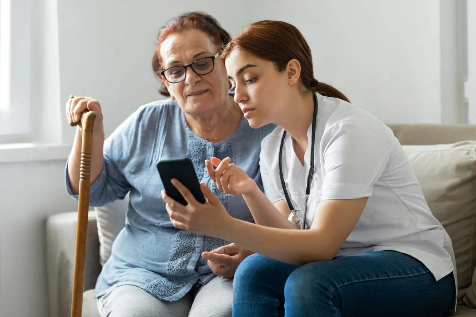 Nurse teaching a senior woman about her medications at home