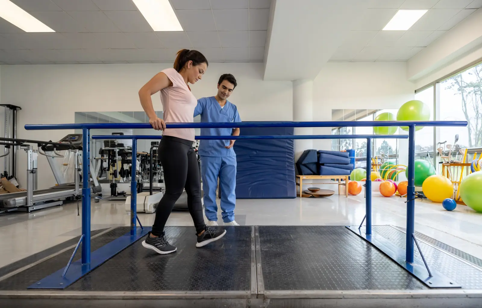Physical therapist guiding a patient through gait training